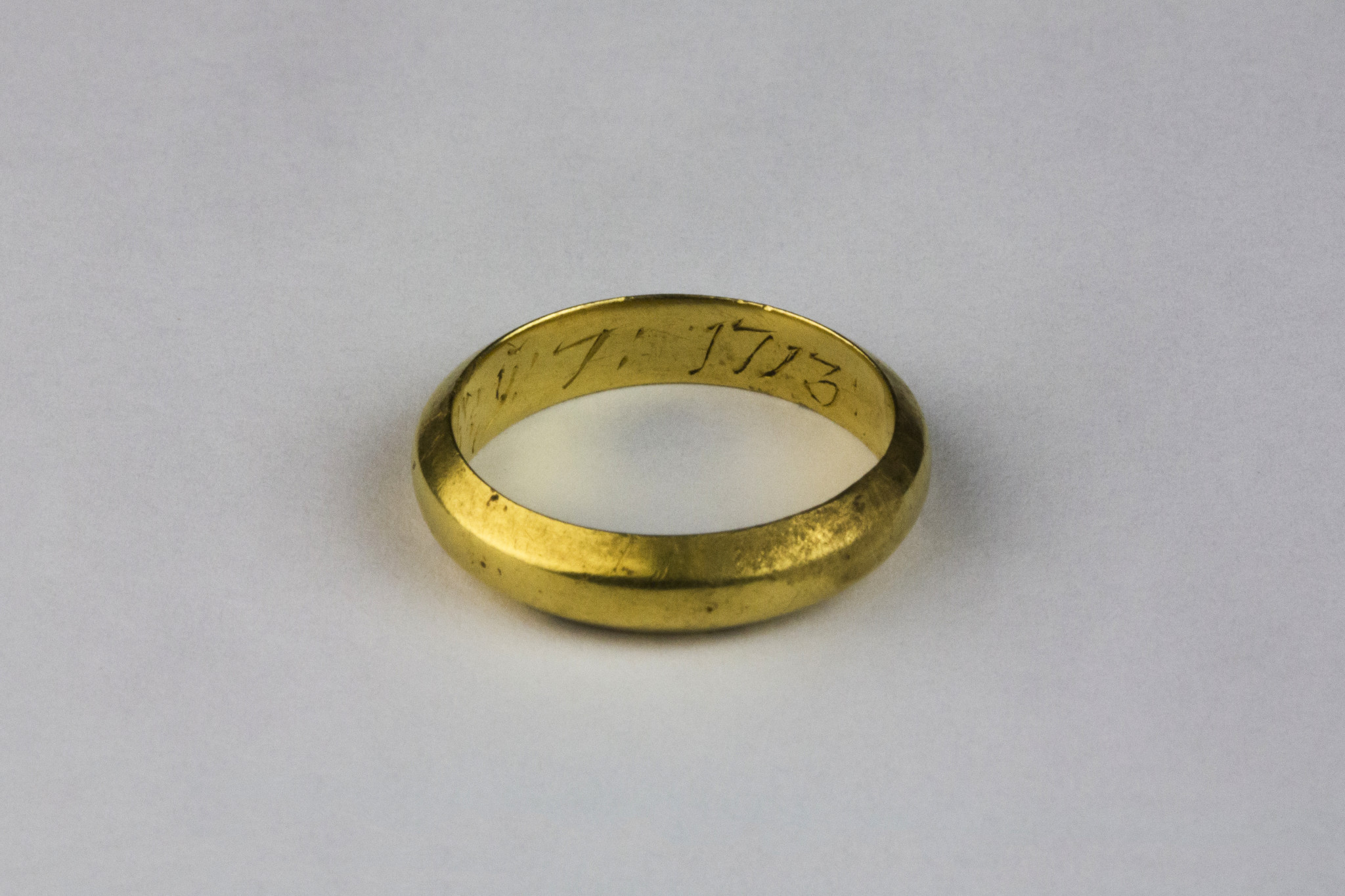 Although there have been relatively few finds thus far, one of the nicest was this gold posy ring. This image shows the year '1713' inscribed inside it (Copyright Rubicon Heritage)